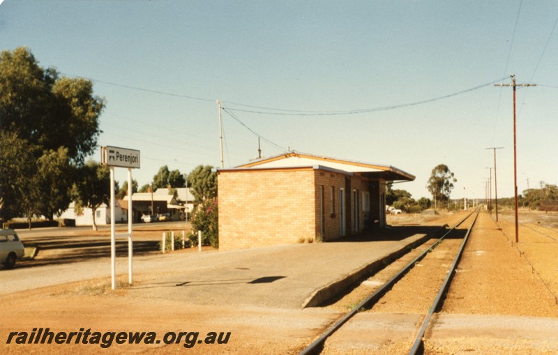 P12952
Station nameboard, station building, telegraph poles, Perenjori, EM line, side and trackside view 
