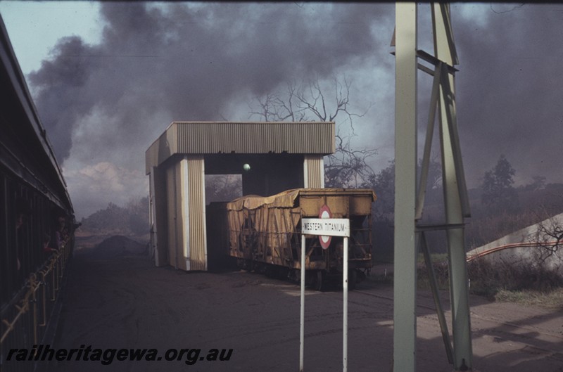 P12973
XA class coal hoppers, station nameboard, Western Titanium, BB line, hoppers possibly being unloaded, view from passing train
