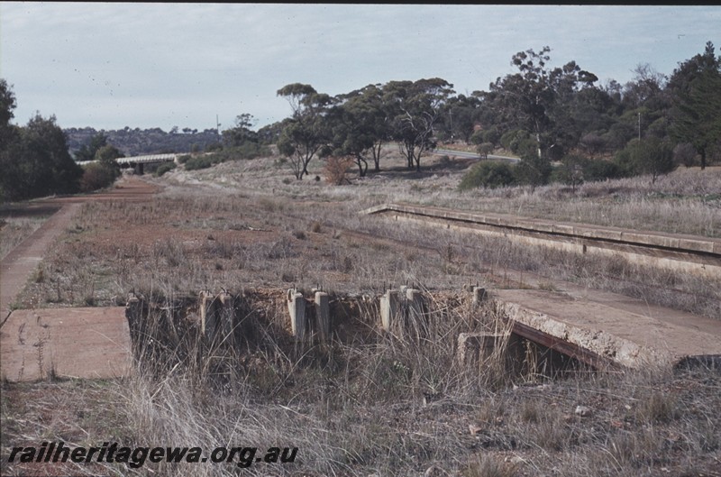 P12976
Station platform, abandoned, Clackline, ER line, view along the right of way, road bridge in the background.
