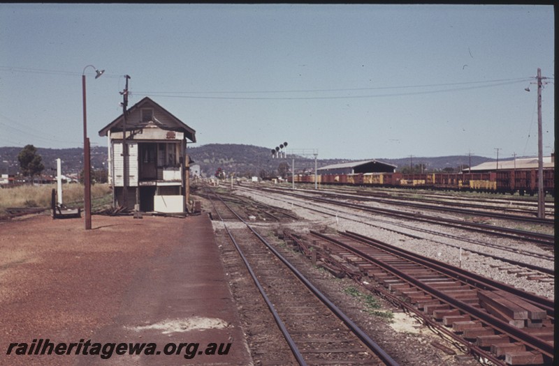 P12986
Signal box, signal gantry with searchlight signals, yard, Midland Box B, end on view.
