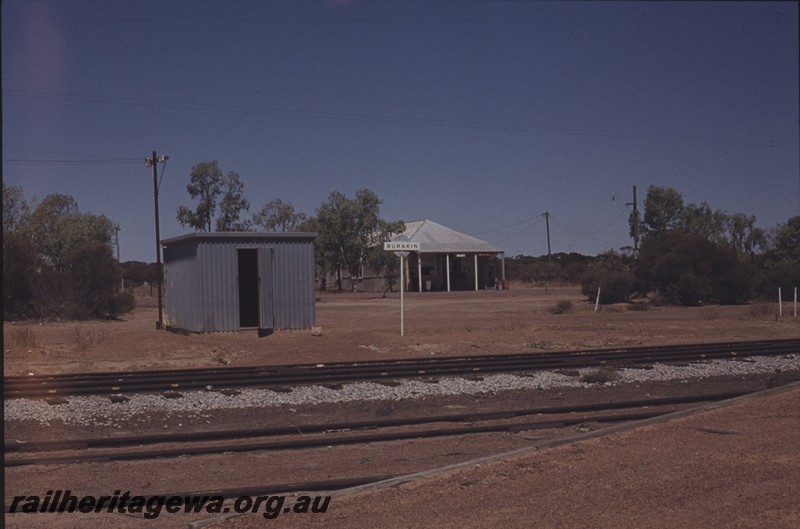 P13011
Shed, nameboard, Burakin, KBR line, view from across the tracks.
