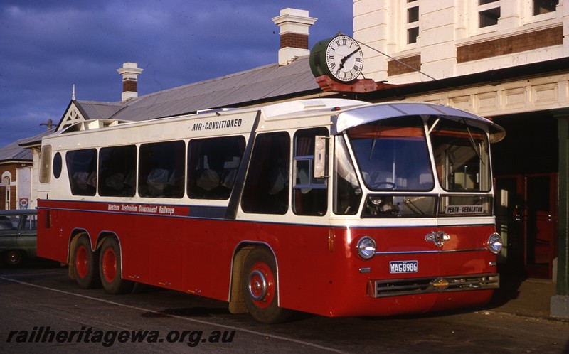P13058
Railway Road Service Leyland bus with tandem rear axles, red and cream livery, Geraldton Station, side and front view.
