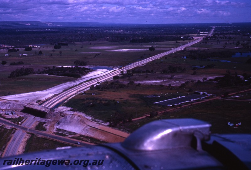 P13086
Standard Gauge construction, Kalamunda road overpass being constructed, aerial view taken from a landing aircraft.
