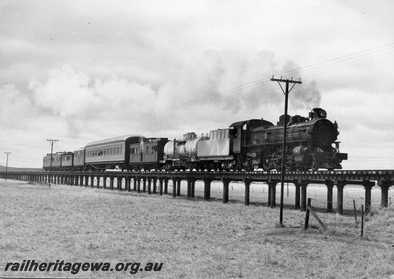 P13101
3 of 3 views of PMR class 720, partially repainted, in the ownership of Steamtown Peterborough in South Australia, in steam hauling a train comprised of brakevans and carriages. This loco was purchased by Steamtown in 1978 and arrived in Peterborough on 17th January 1979, crossing the Black Rock Bridge
