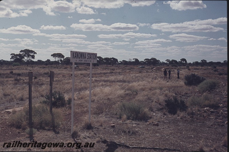 P13159
Platform, location nameboard, Kanowna, Kalgoorlie to Kanowna line, platform abandoned and overgrown with weeds, view along the platform.
