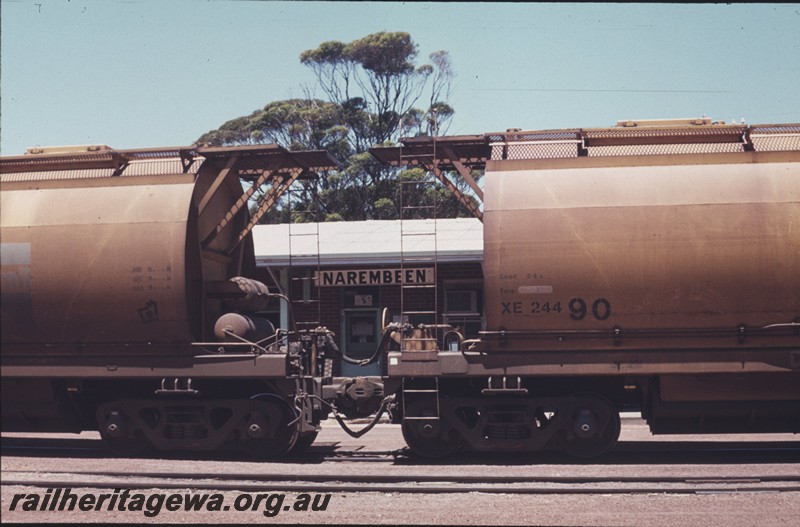 P13273
XE class 24490 coupled to another XE class hopper, Narembeen, NKM line, station nameboard visible between the wagons.
