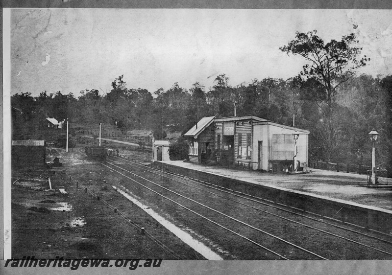 P13308
Station buildings, Out of Shed on platform, signal box, station platform oil lamp, signals, Wooroloo, ER line view across tracks looking west. (scanned print located in MC1B2G)
