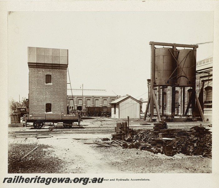 P13391
35 of 67 views taken from an album of photos of the Midland Workshops c1905. Power House, - H class 3075 four wheel low sided wagon with a single brakeshoe, Water Tower And Hydraulic Accumulator.
