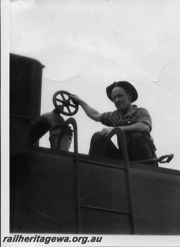 P13473
3 of 3 images taken at Norseman, CE line, of the last steam working on the Coolgardie to Esperance line, ASG class 65 hauled ASG class 55 dead on No.156 goods ex Norseman. Punper Bluey Wiggins filling the rear tank with water. 
