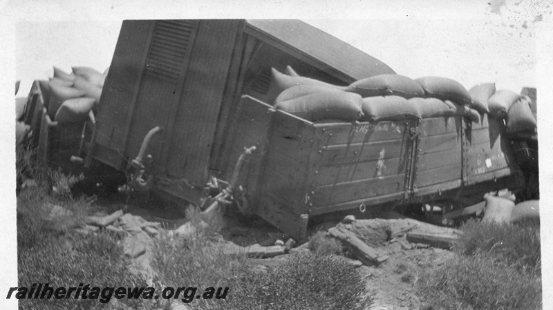 P13505
5 of 5 views of a derailment, date and location Unknown, view shows derailed and smashed wagons with bagged wheat strewn on the ground.
