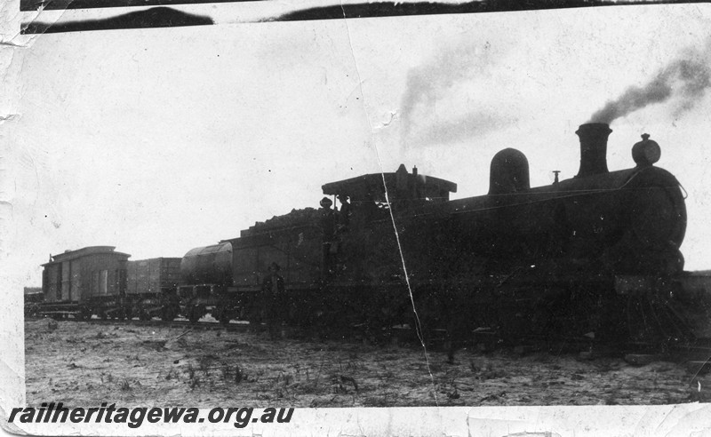 P13506
1 of 7 images of O class 91, date and location Unknown, side and front view, a clerestory roofed brakevan in the background
