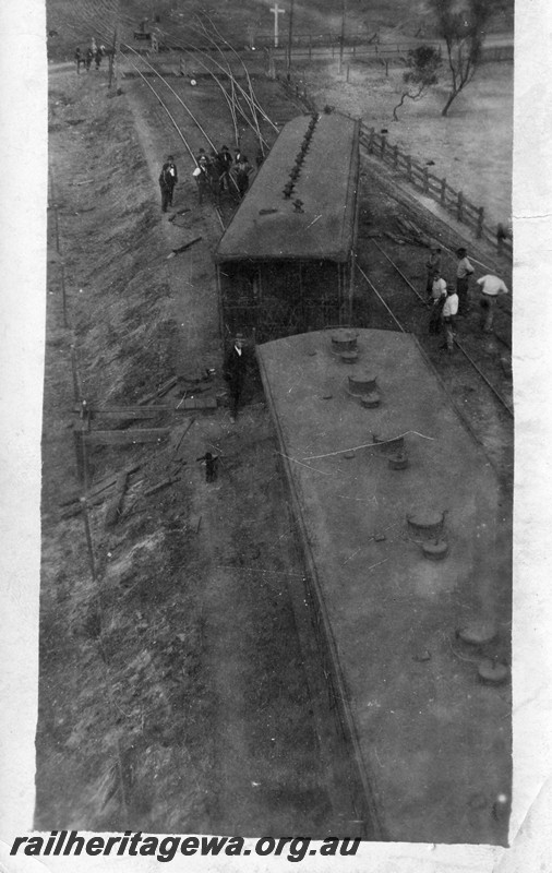 P13527
4 of 4 views of derailment of a platform ended carriage, date and location Unknown, elevated view along the train showing the derailed carriage straddling the tracks.
