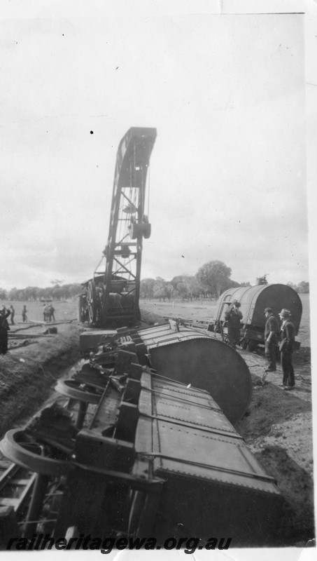 P13532
2 of 3 views of the derailment at Dumberning, BN line showing steam crane No.23 lifting wagons back onto the track.
