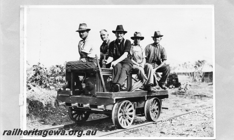 P13604
Five gangers riding upon a motorised ganger's trolley, front and side view
