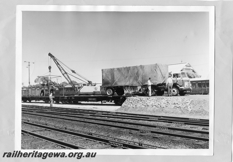 P13623
QU class 25001 with a Railway road service Commer truck partially on board, group of onlookers behind the wagon

