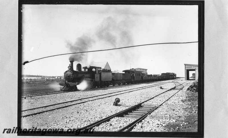 P13632
G class loco, four wheel wooden water tank wagon, AL class 190 on mixed train, station building, goods shed at Nannine, NR line, a metal louvered FA class van can be seen through the open doors of the goods shed
