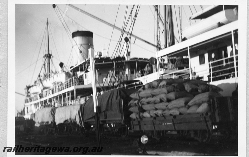 P13650
Jetty wagons loaded with whale meal about to be loaded onto a ship, Carnarvon
