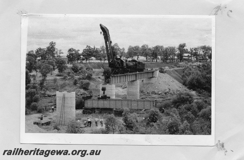 P13668
Cowans Sheldon 60 ton crane No.31, steel girder bridge under construction, girder being lifted into place. 
