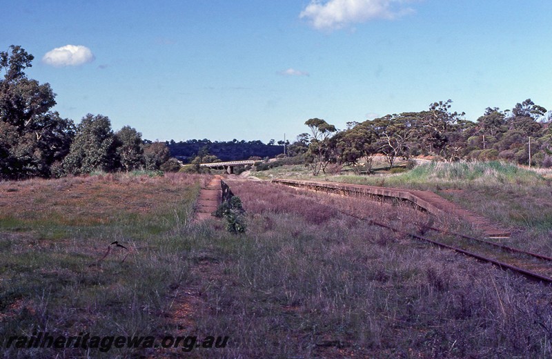 P13677
Station platforms, abandoned, Clackline, ER line, view along the right of way, road bridge in the background.
