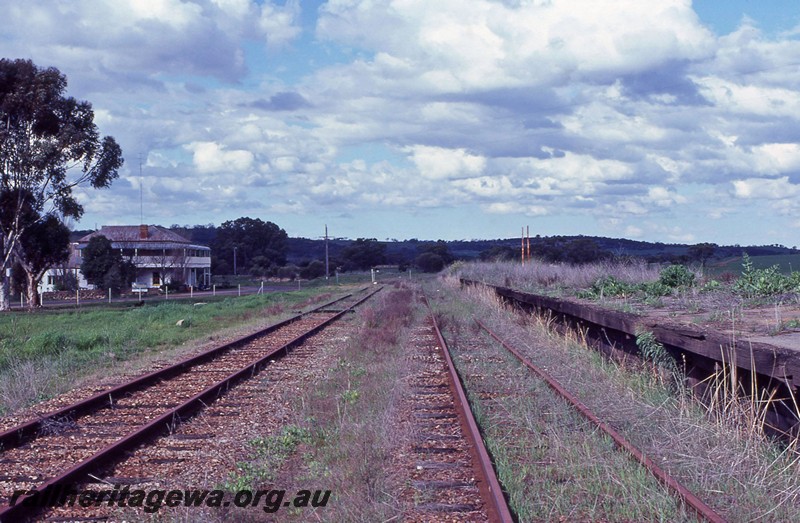 P13680
Station platforms, abandoned, Spencers Brook, ER line, view along track, hotel in background.
