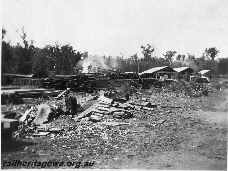 P13694
4 of 6 images of the mill town of Jarnadup, renamed Jardee in 1925, overall view of the mill site showing stacked timber in the foreground and the mill buildings in the background

