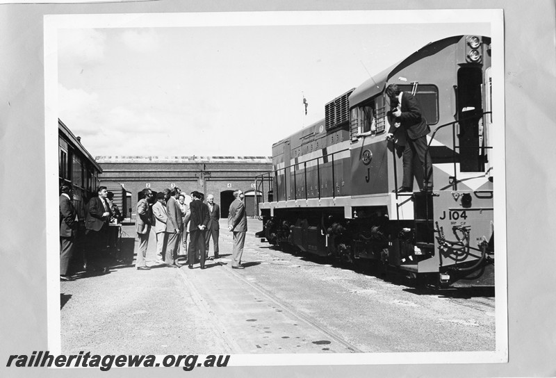 P13713
J class 104 in International Safety livery, dignitaries looking on, forecourt, Midland Workshops, side and end view
