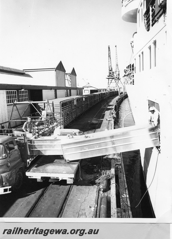 P13729
CXB class sheep wagons, wharf cranes, Fremantle Wharf, unloading sheep for shipment to the Arabian Gulf, harbour side view.
