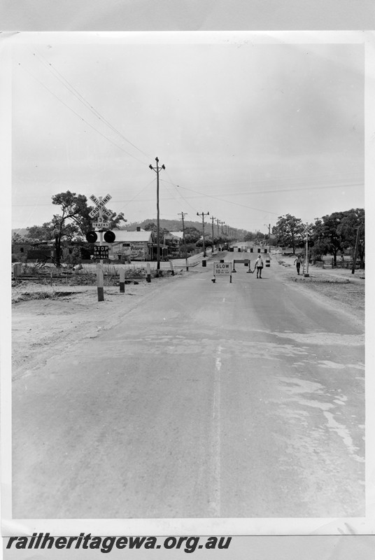 P13732
Level crossing on Great Eastern Highway, Bellevue, view along the road looking east, shows the track to the Helena Vale racecourse
