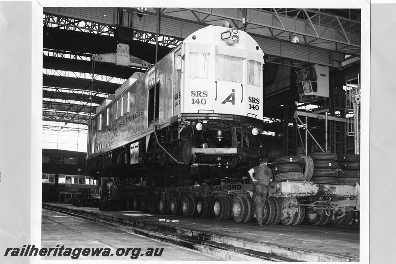 P13737
Speno Rail Service SRS140 being loaded on t a multi wheeled road trailer, side and front view
