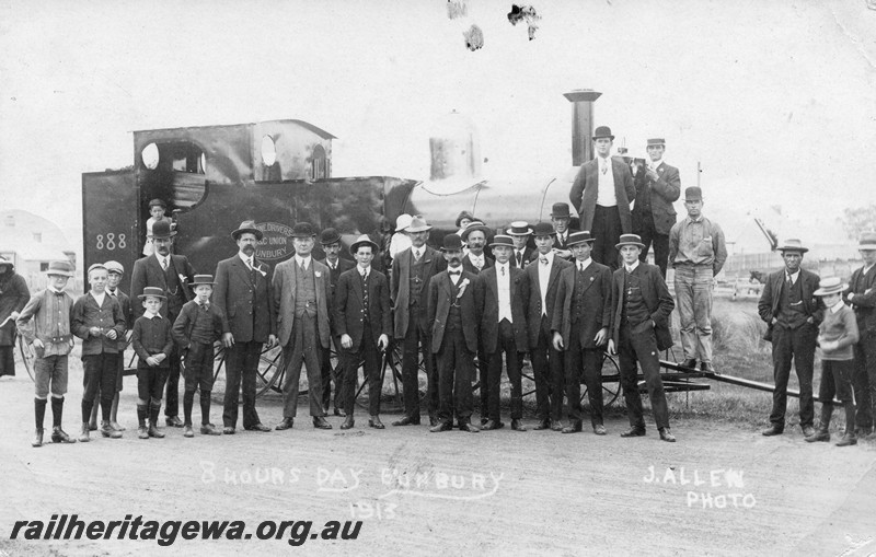 P13761
Railway workers in formal dress, lined up in front of a mock up of a locomotive, to celebrate 