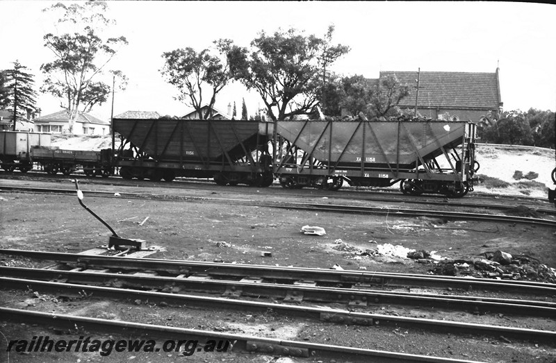 P13857
XA class 11156 and XA class 11158 coal hoppers, East Perth Loco Depot, side view, XA 1156 appears to have wooded planked sides.
