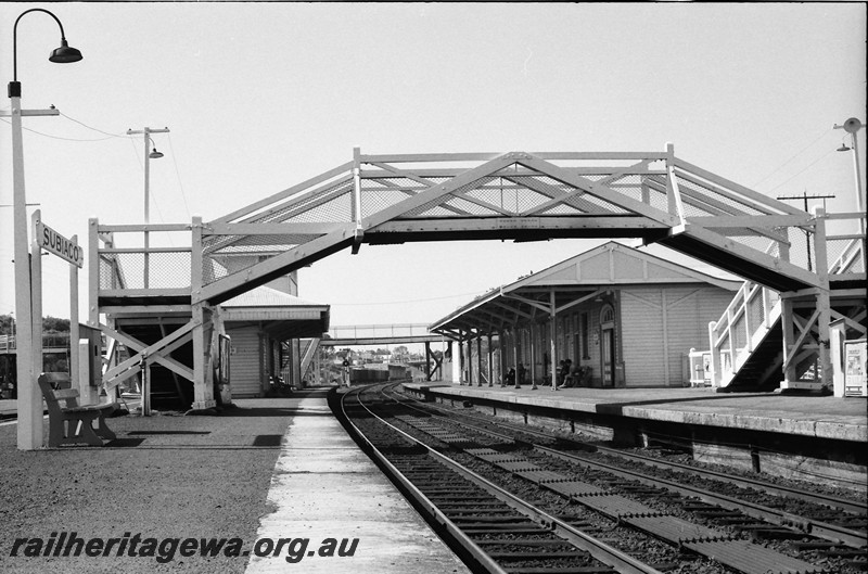P13879
2 of 6 views of the station buildings at Subiaco, view of the footbridge and the station buildings looking towards Perth along the tracks. (compare with similar but historic view P14091)

