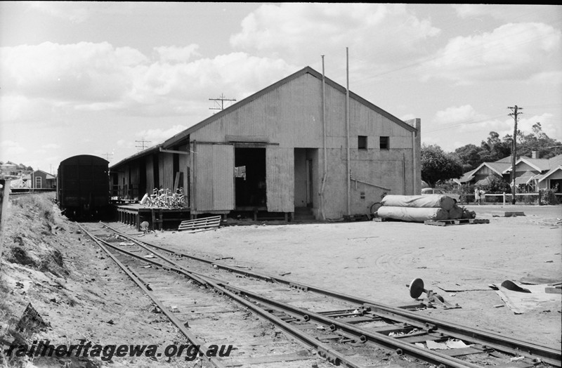 P13910
K. W. Thomas (later TNT) freight forwarding shed, Maylands, end view looking east, Meltham station in the background.
