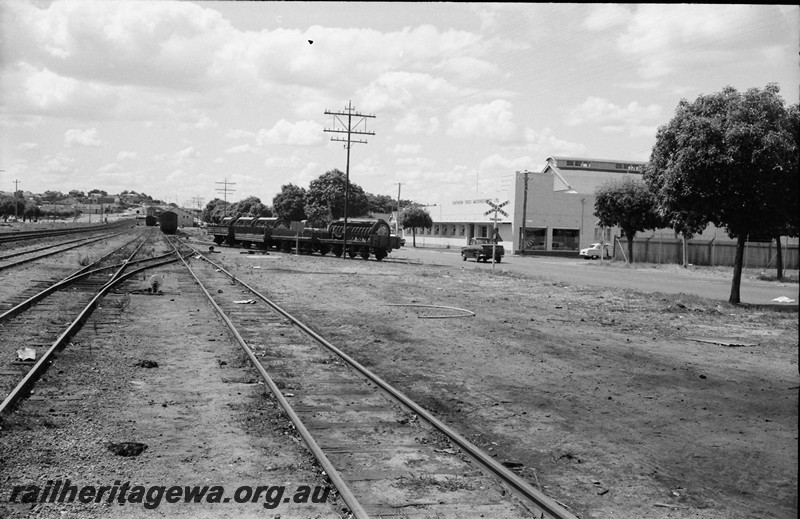 P13911
Wagons loaded with agriculture machinery on spur line leading to Massey Ferguson's yard in Maylands, view along the track looking east
