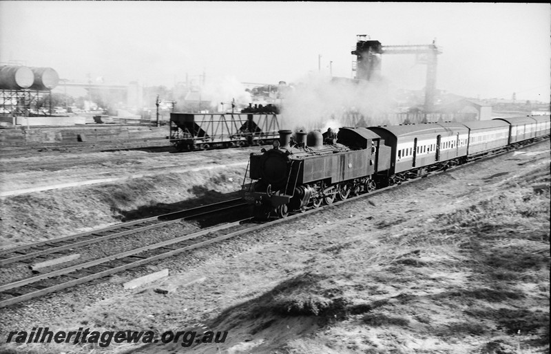 P13971
2 of 17 images of locos, trains and buildings at the East Perth Loco Depot, DD class 600 on a suburban passenger train heading towards Midland passing the coaling tower.
