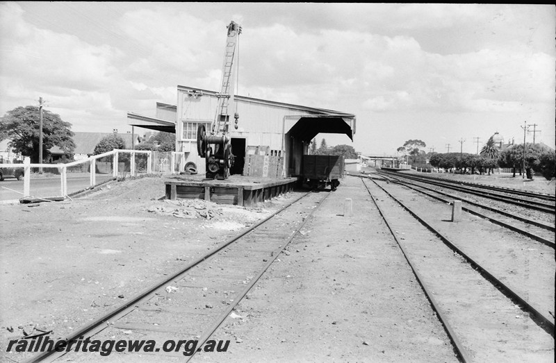 P14020
Platform crane, goods shed, yard, Maylands, ER line, view along the tracks showing an end of the shed.
