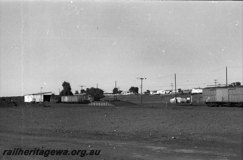 P14021
Station precinct, Meekatharra showing the goods shed, loading platform, X class loco and wagons in the yard, overall view of the precinct
