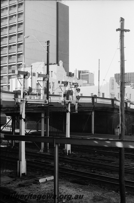 P14036
Bracket signals with shunting dollies near the Barrack Street Bridge, Perth Station, view across the tracks looking south.
