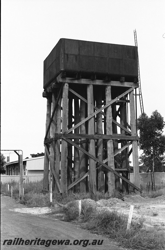 P14055
Water tower, 25,000 gallon cast iron water tank, view of two sides, standpipe, trainmens barracks, Tambellup, GSR line.
