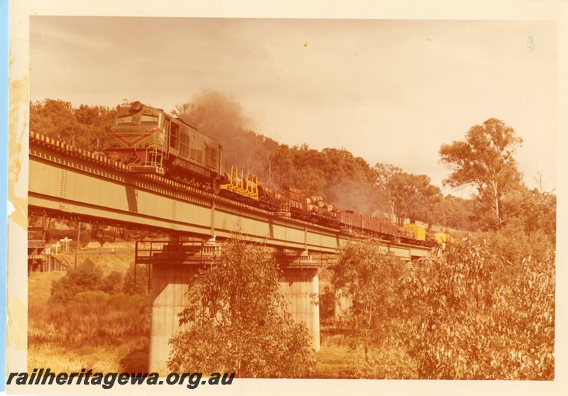 P14097
X class 1012 on curved steel girder bridge at Bridgetown with a mixed freight train, PP line.
