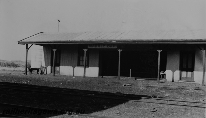 P14116
Station building, nameboard, Marble Bar, PM line, trackside view.c1947
