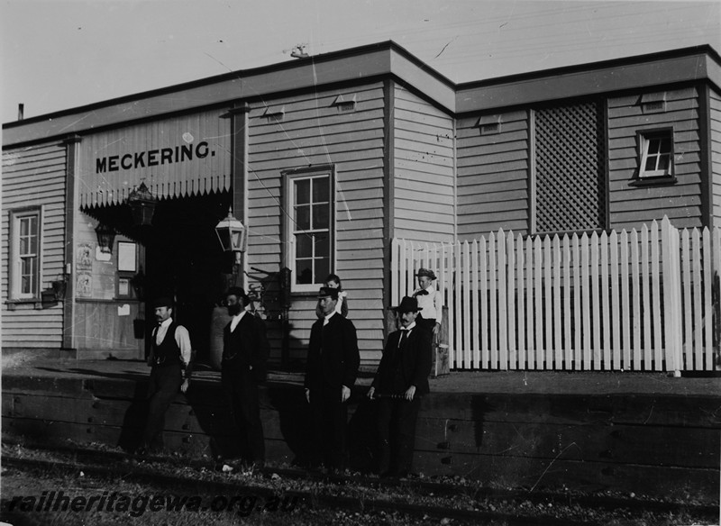P14119
Station building, nameboard, Meckering, EGR line, employees in front of the building, the Officer in Charge is second from the right.

