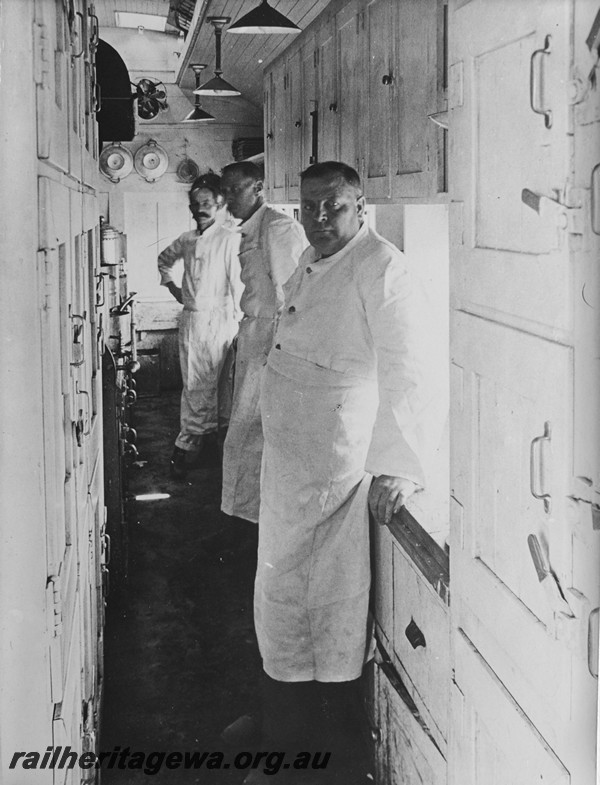 P14142
Commonwealth Railways (CR) dining carriage, internal view of the galley with the crew..
