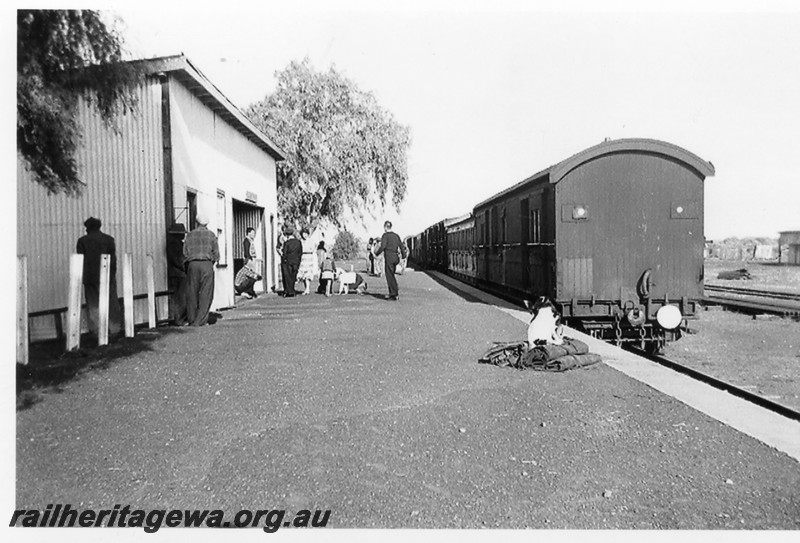 P14245
Station building, with staff and passengers on the platform, Kookynie, KL line, mixed train at the platform, view along the platform. Looking south.
