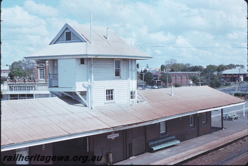 P14259
1 of 4, Station building, signal box, island platform, nameboard, seats, Bassendean, ER line.
