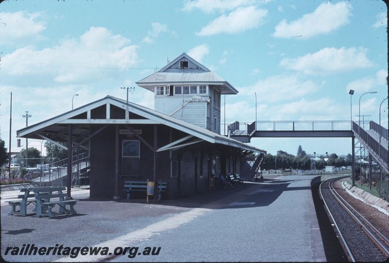 P14260
2 of 4, Station building, end view, signal box, footbridge, seats, island platform, Bassendean, ER line.
