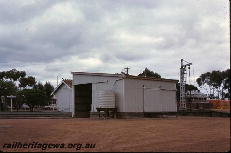 P14271
Goods shed, end and side view, loading crane, loading platform, nameboard, end of station building, Quairading, YB line.
