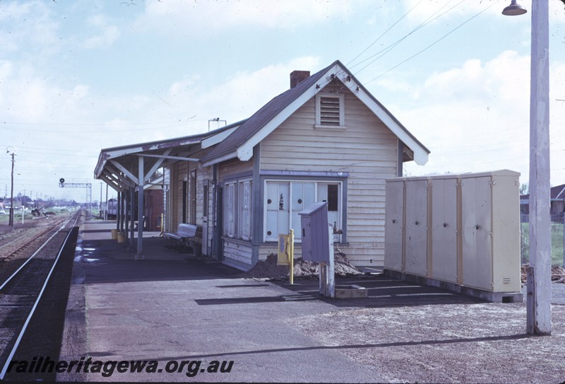 P14311
1 of 3, Station buildings, fire hose box, relay cabinets, station furniture, gantry signal, passenger platform, Cannington, SWR line.
