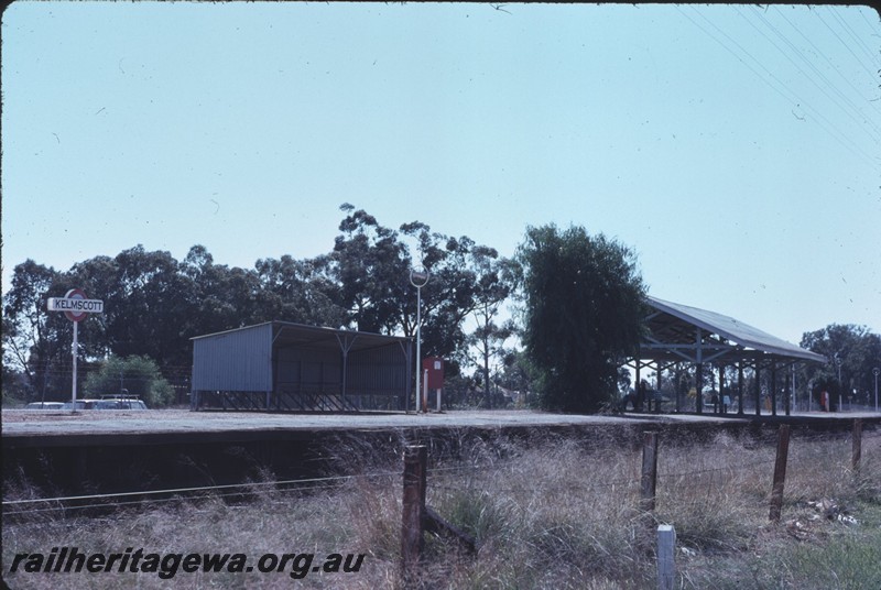 P14318
2 of 2, Station buildings, passenger platform, nameboard, fire hose box, bicycle racks, Kelmscott, SWR line.
