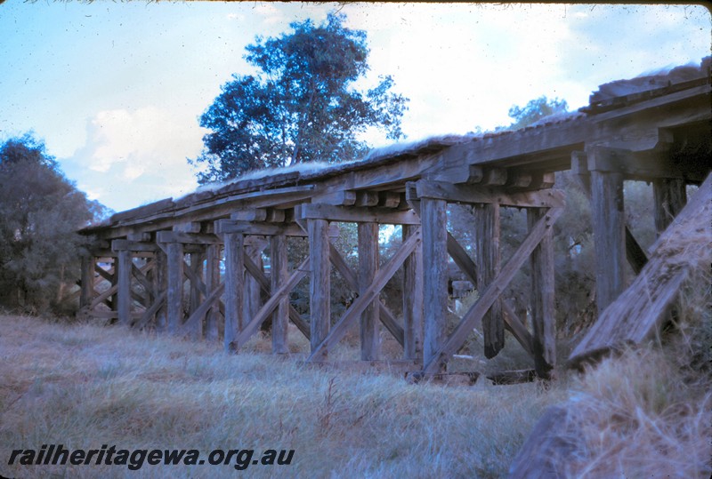 P14448
Trestle bridge, Bellevue, UDRR line, view from the ground level at the abutment, abandoned and dilapidated.
